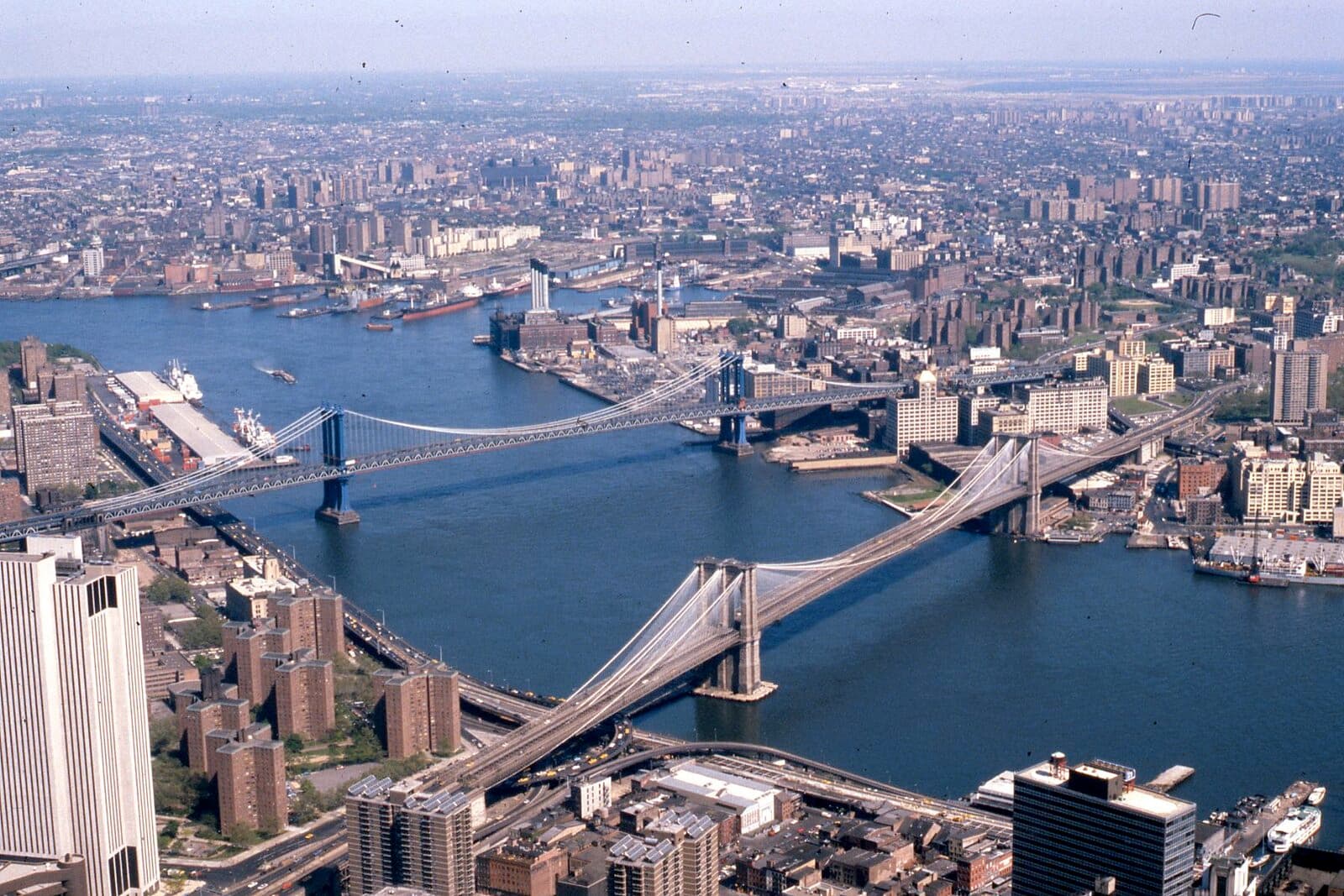 New York, NY — Manhattan and Brooklyn bridges on the East River, New York City, 1981